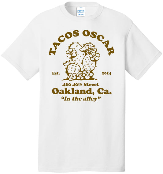 White t-shirt with brown 'Tacos Oscar' logo and text on a white background